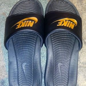 black ans gold nike slides